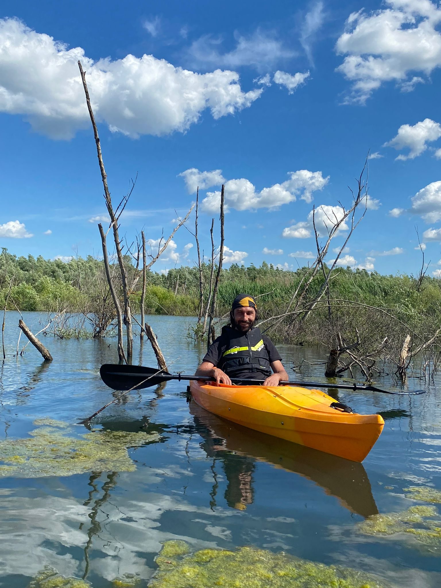 Paddler enjoying the Glide 9.5 on a calm lake